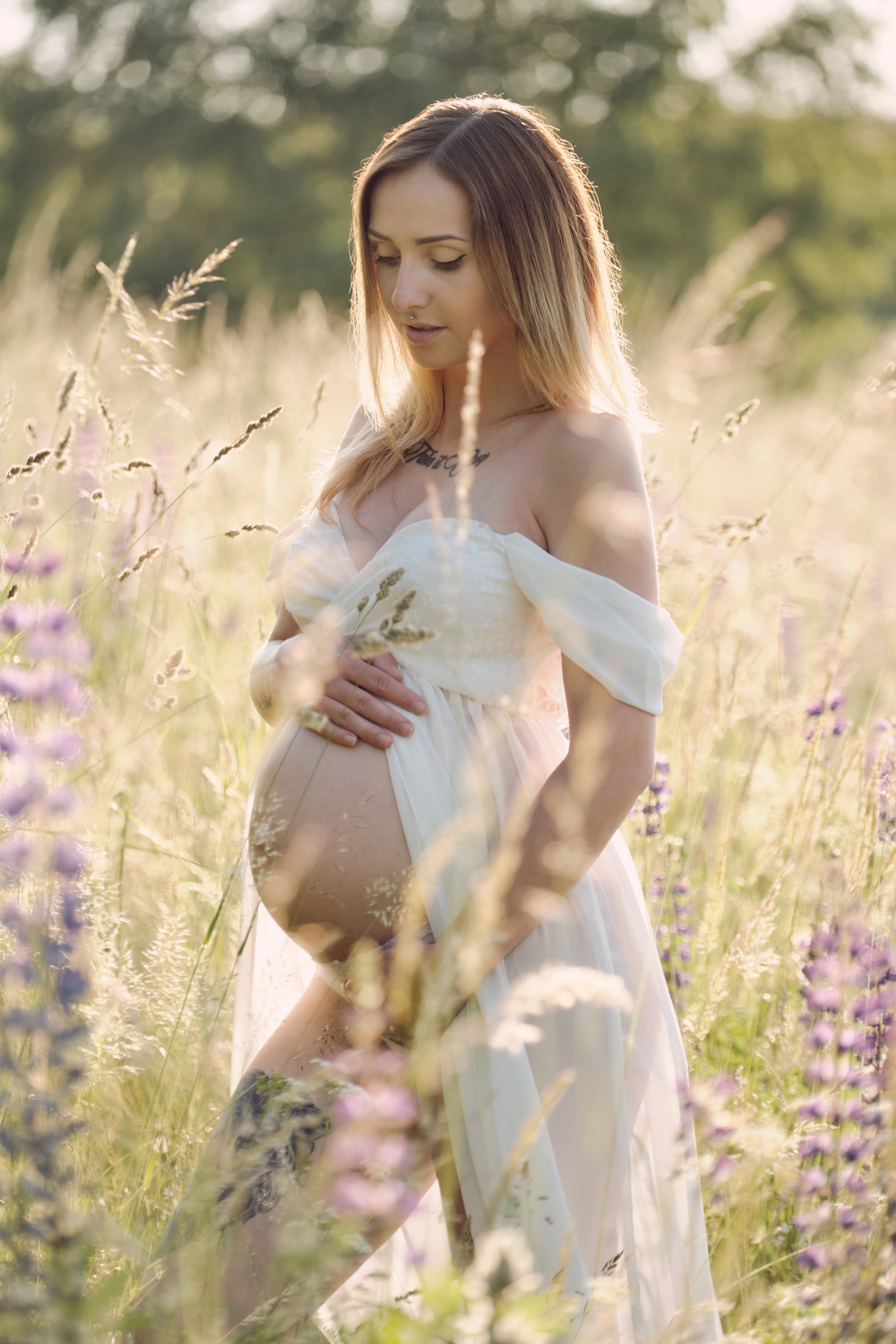 Pregnant Woman Posing In a Field with Bump